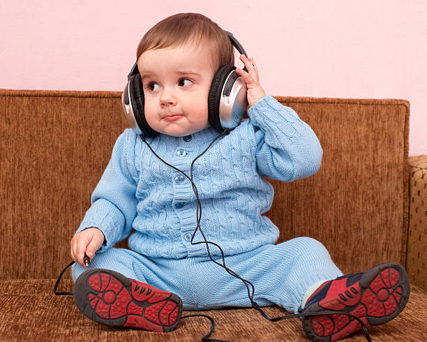 istock Smart toddler examining headphones 96696900