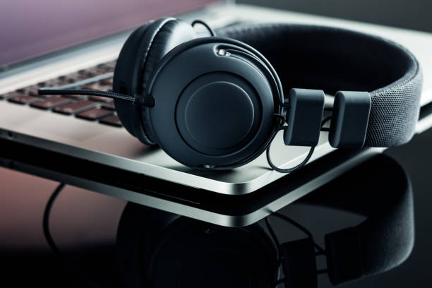 istock Headphones and laptop on black table. 966969678