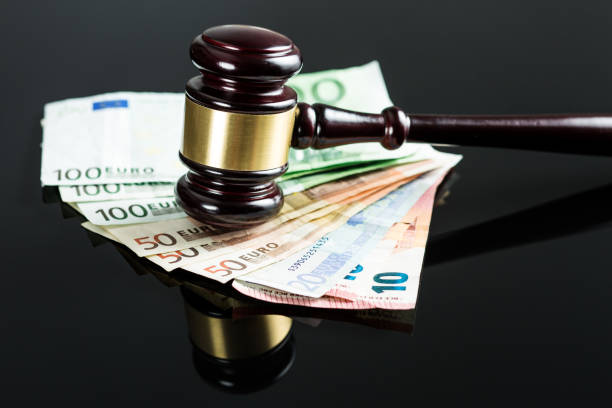 istock Gavel and euro money on black table. 966969720