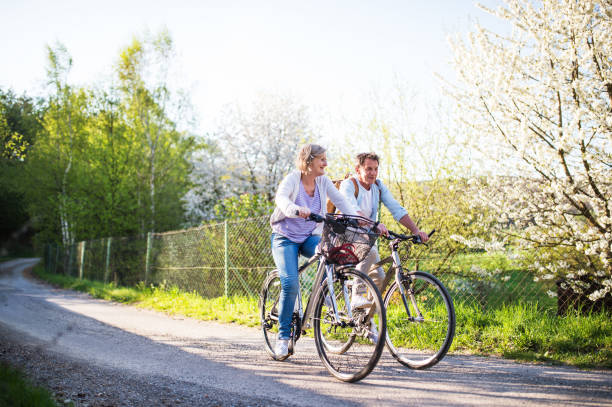 istock Senior couple with bicycles outside in spring nature. 966979840