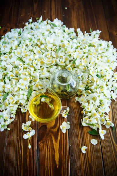 istock Tea with jasmine flowers in a glass teapot 966981374