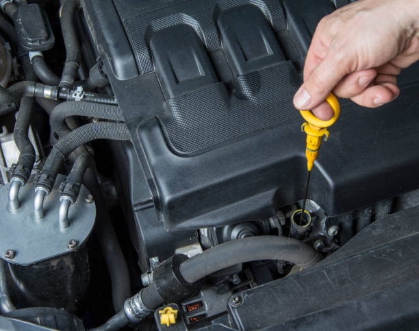 istock Man is checking the oil in the car engine 966986404