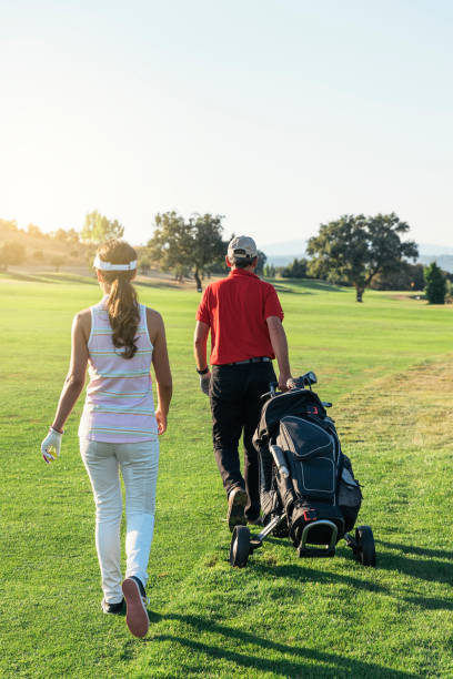 istock Golfer and Caddie playing golf. 966992726