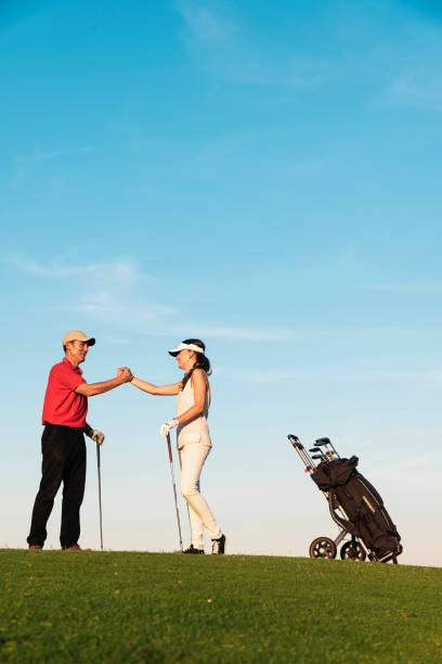 Golfer and Caddie playing golf.