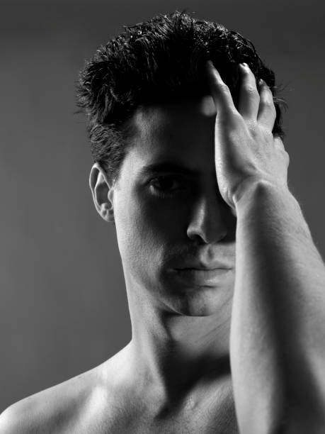 istock black and white man passing his hand through his hair 966994168