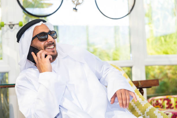 istock Cheerful wealthy Arab Businessman talking on his phone 966994928