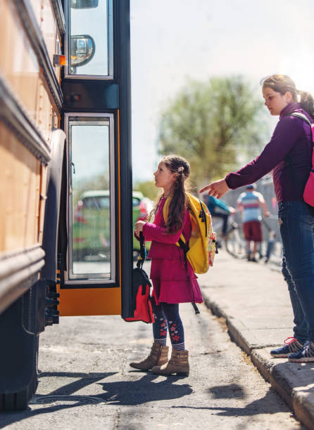 istock School kids entering in the school bus 967006718