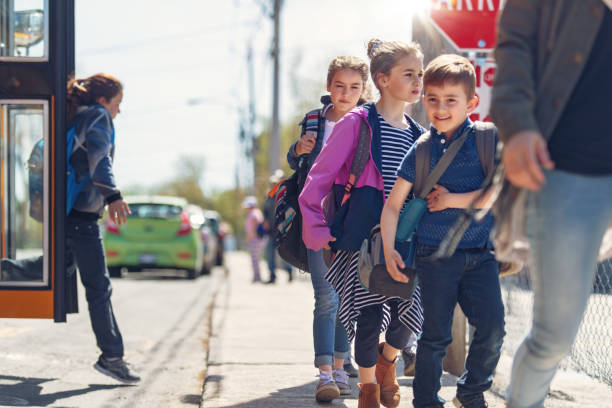 istock School kids getting out the school bus 967007056