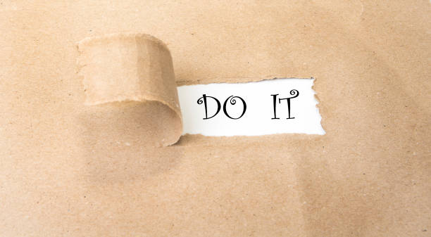 istock Blank torn brown paper revealing new challenges. Do it . 967007752