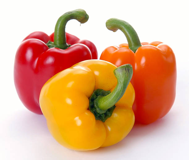 istock Red, yellow, and orange peppers isolated on white 96701170