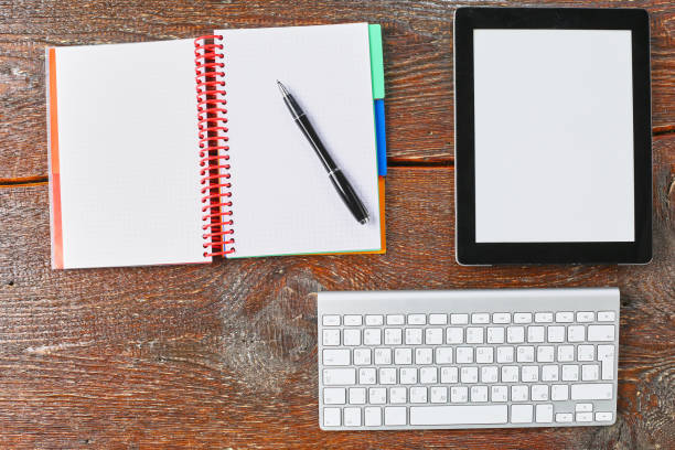 istock Laptop, tablet and notebook are on a wooden table 967031370