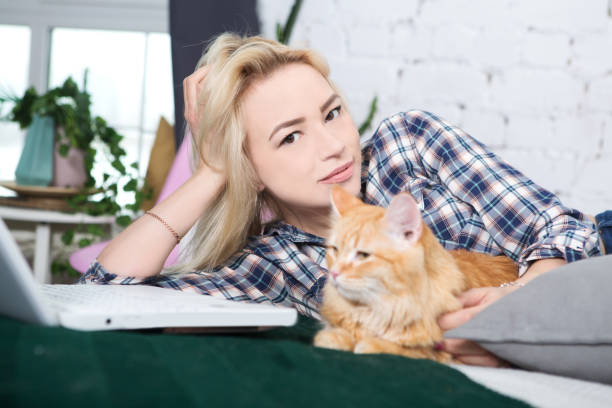 istock Young woman playing with cat in home. 967035292