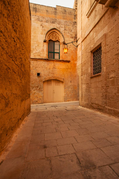istock Medieval street illuminated at dusk, Mdina Old City, Malta 967036344