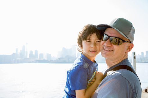 Father and son beside Lake Ontario with