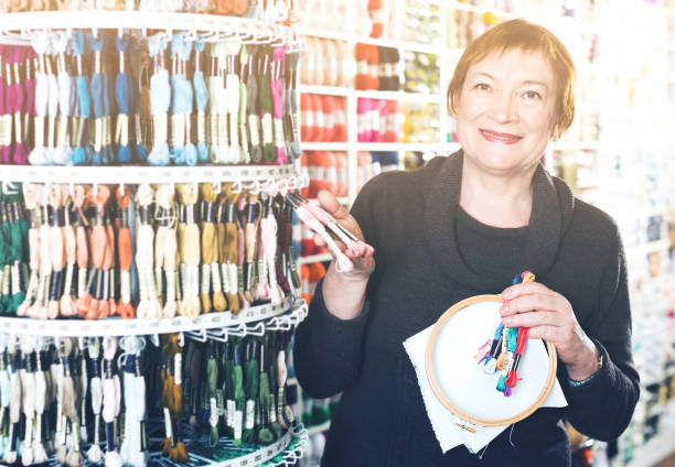 istock Woman buying embroidery accessories 967040140
