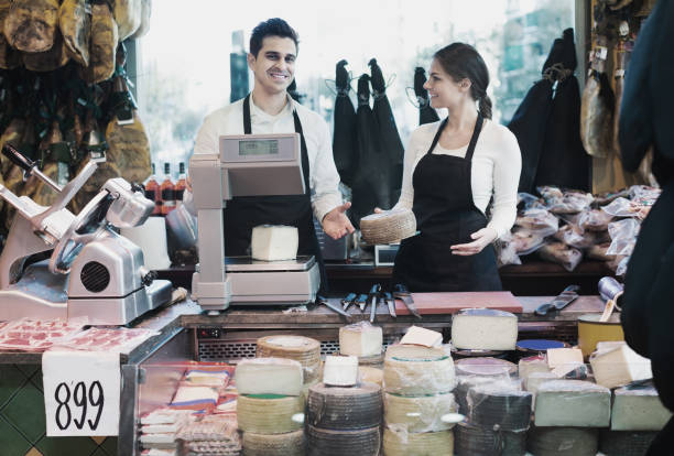 istock Two workers selling cheese and sausages 967040442