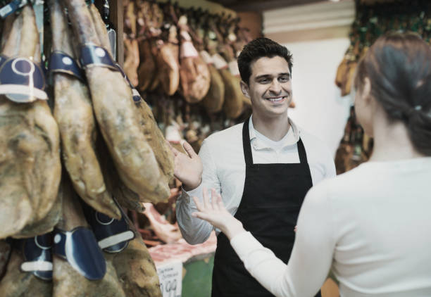istock Young brunette choosing iberico and serrano jamon 967040460