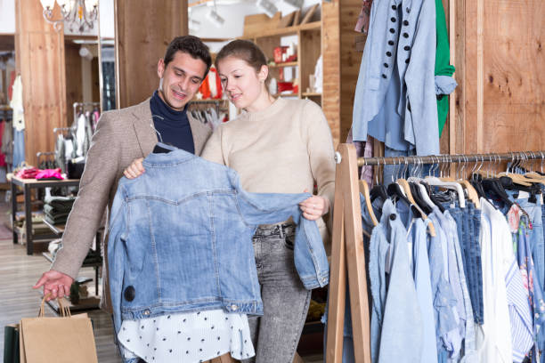 istock Couple is choosing jeans blouse for her 967040544