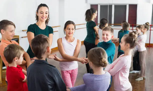 Photo of Boys and girls studying folk dance in studio