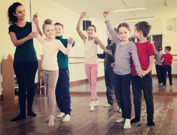 istock primary school age boys and girls dancing pair dance 967041680