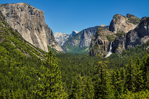 The Yosemite Valley with its iconic granite monoliths known as El Capitan and Half Dome as well as the falling waters of Bridal Veil Falls.