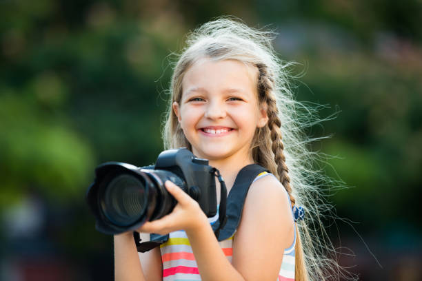 istock little girl with camera outdoors 967059314