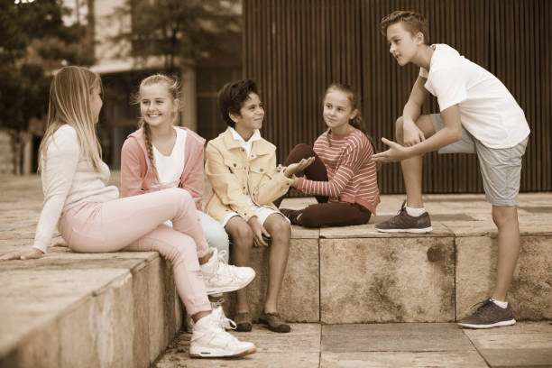 istock Two boys and three girls are talking about play on walk 967069246