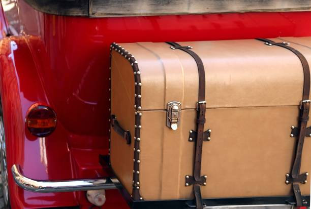 istock old leather trunk attached to the red vintage car 967073978