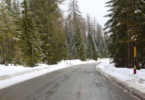 istock icy mountain road with snow at the edges 967075126