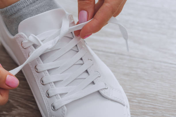 istock Woman tying shoelaces 967080112