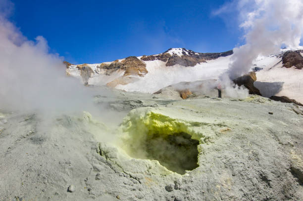 istock steaming crater of active volcano covered by snow 967085428