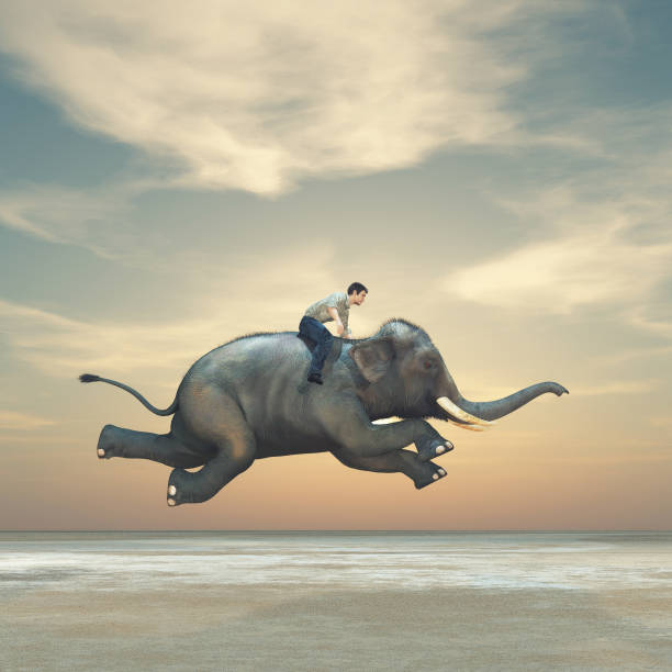 istock Surreal image of a man riding an elephant 967086692