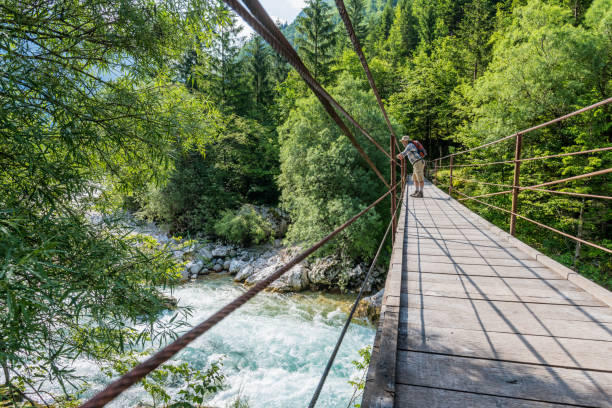 istock Senior man on suspension footbridge at River Soca 967090590