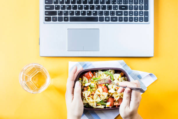 istock Vegetable salad with macaroni bowls with cheese in a container for lunch at the office workplace near the laptop. Top view, flat lay 967093176