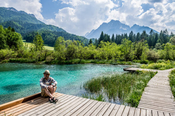 istock Senior Man by the green lake Zelenci 967094322