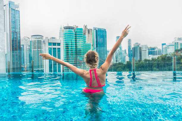 istock Woman enjoying the view from swimming pool 967099786