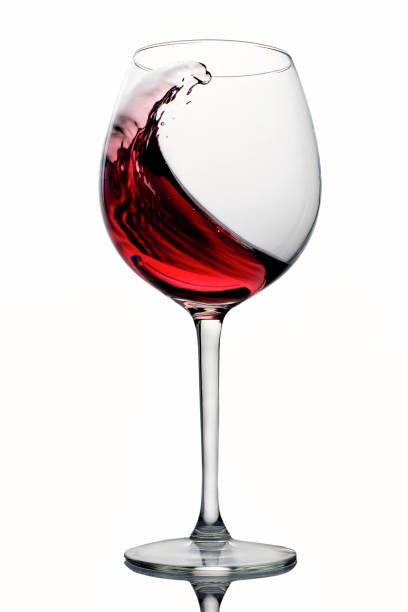 istock moving red wine glass over a white background 967103974