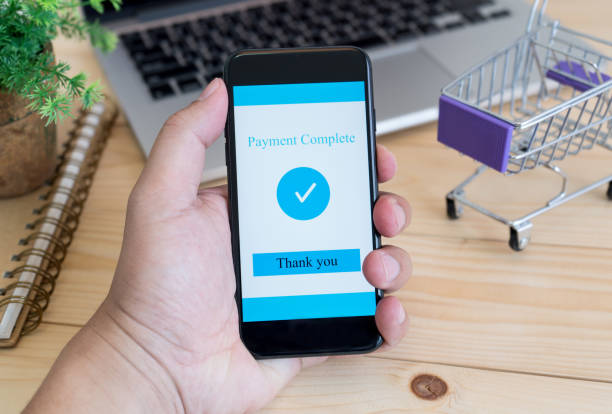 istock Hands using smartphone and laptop computer for online shopping at home 967108754