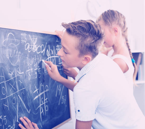 istock Brother with sister are doing homework on desk 967109874