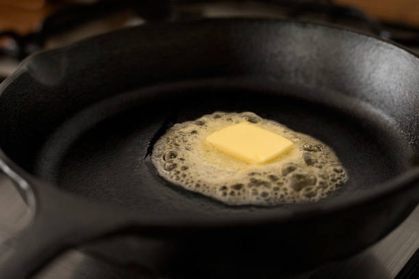 istock A butter pat melting on a black cast iron frying pan. 967110048