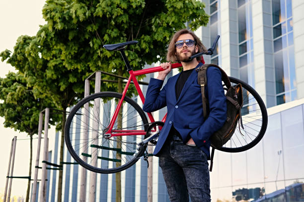 istock A man holds red single speed bicycle on his shoulder. 967110064