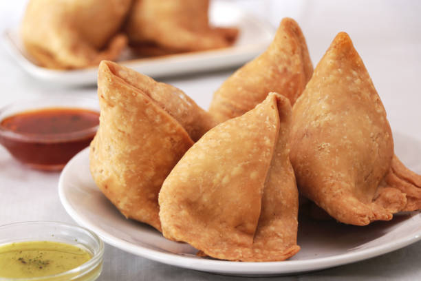 Samosa And Chutney Samosa filled with smashed potatoes ,green peas and hot spices. SAMOSA stock pictures, royalty-free photos & images