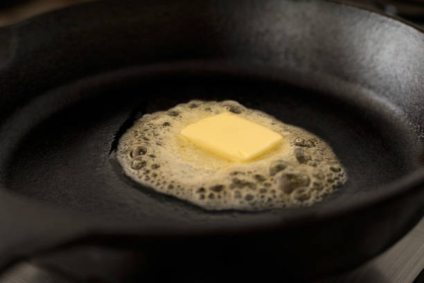 istock A butter pat melting on a black cast iron frying pan. 967110112