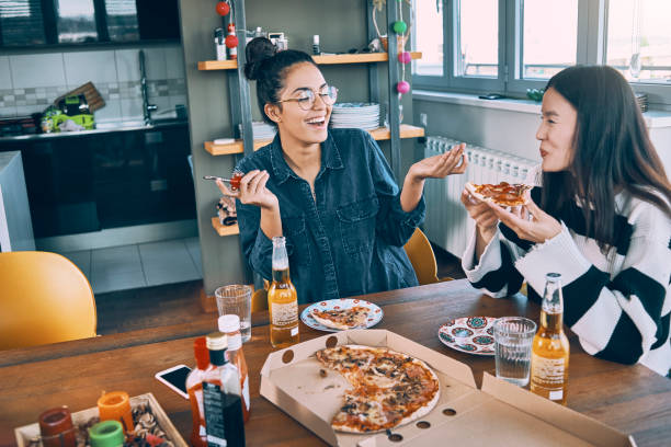 istock friends having pizza at home for lunch together 967117422