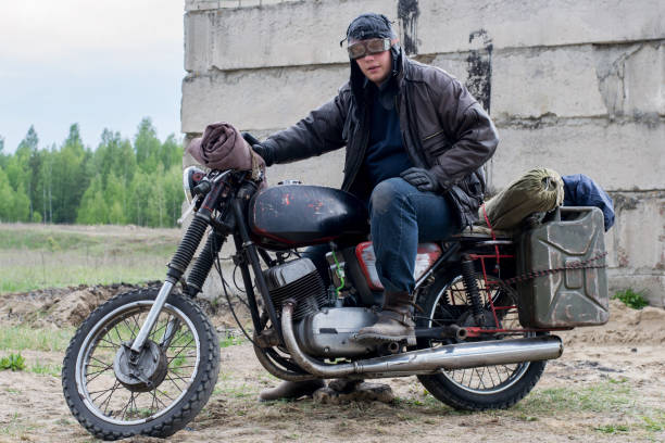 istock A post apocalyptic man on motorcycle near the destroyed building 967121572