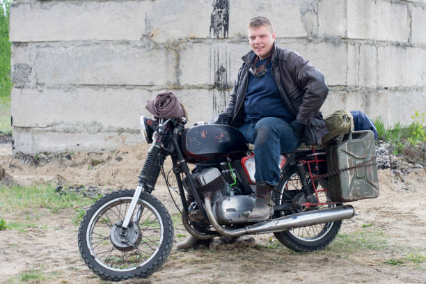 istock A post apocalyptic man on motorcycle near the destroyed building 967121704