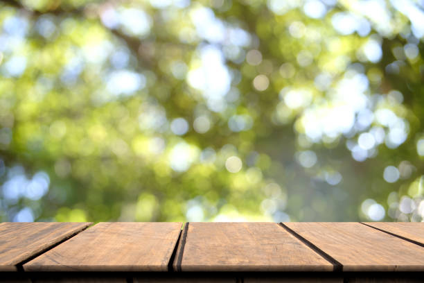 istock Empty wooden table on front for presentation product blurred nature background, mock up, copy space 967124876