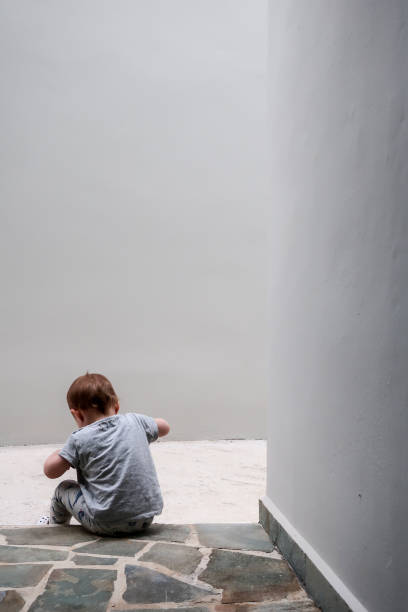 istock Child puts on the shoes on the door step 967125372