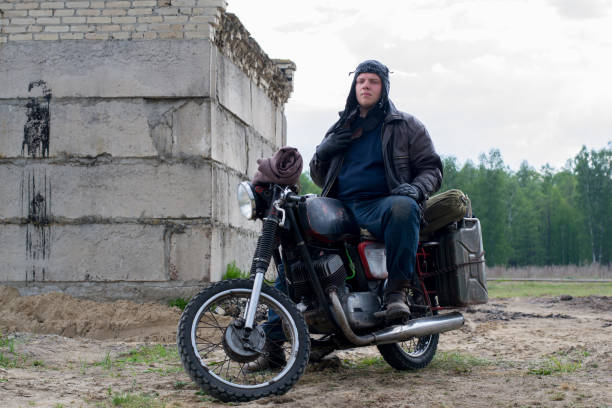 istock A post apocalyptic man on motorcycle near the destroyed building 967125472