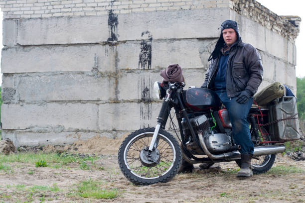 istock A post apocalyptic man on motorcycle near the destroyed building 967125744